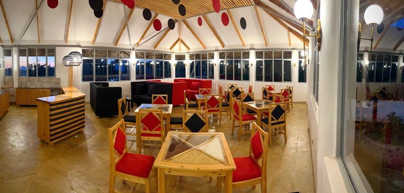 Dining room beneath a timber roof