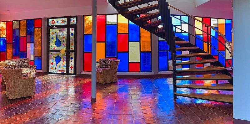 Lounge with stained glass windows and a spiral staircase