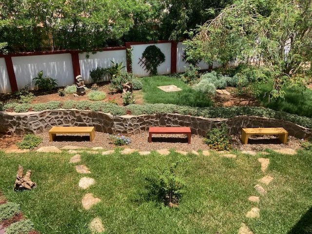 Lawn with stepping stones and wooden benches